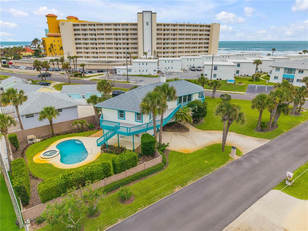 An elevated house with a turquoise deck and a swimming pool near the ocean — 320 DUE EAST STREET, NEW SMYRNA BEACH, FL