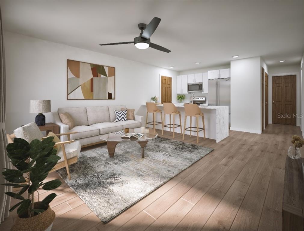 This is a rendering of an open-concept living room and kitchen with wood-look flooring — 15090 CANNELL LANE, PORT CHARLOTTE, FL