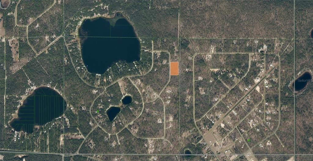 An aerial map view shows a rectangular plot of land highlighted in orange — 143 QUAIL WAY, HAWTHORNE, FL