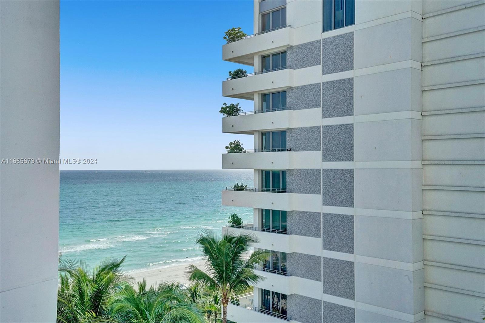 A high-rise building with stacked balconies overlooks the ocean and a sandy beach — 4391 Collins Ave # 915, Miami Beach FL 33140, MIAMI BEACH, FL