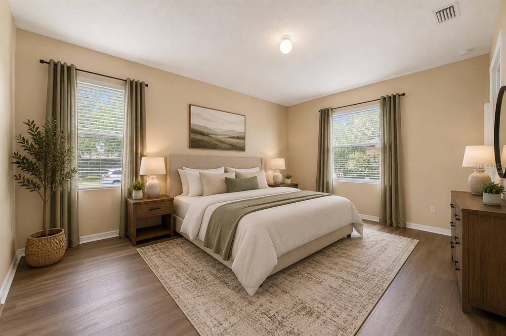 A bedroom features a king bed, two nightstands, a dresser, and two windows with curtains — 13589 HUNTERS POINT STREET, SPRING HILL, FL