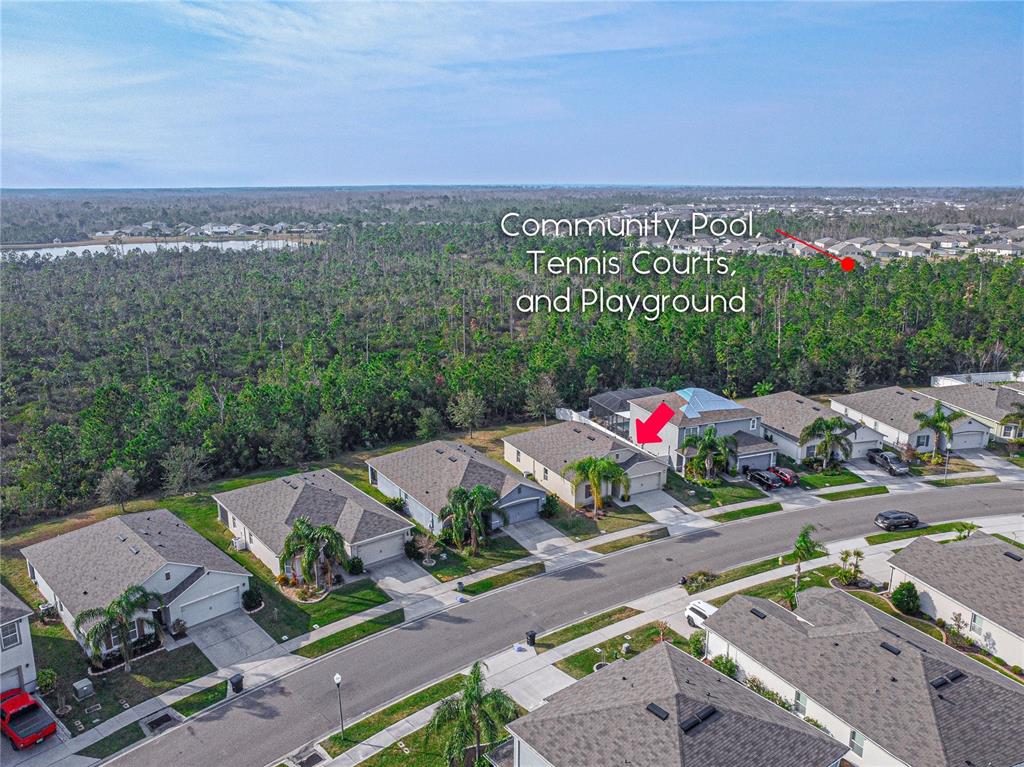A white sign with the text Coastal Woods stands on a stone base outdoors — 2952 GIBRALTAR BOULEVARD, NEW SMYRNA BEACH, FL