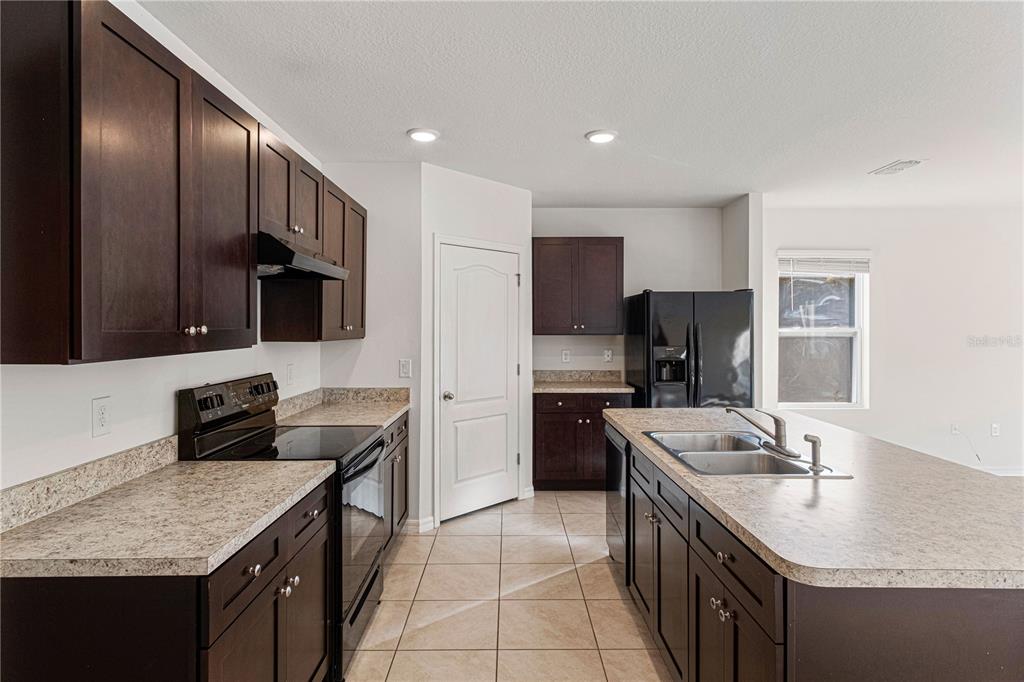 An aerial view shows a house with a large backyard, a pool enclosure, and landscaping — 2952 GIBRALTAR BOULEVARD, NEW SMYRNA BEACH, FL