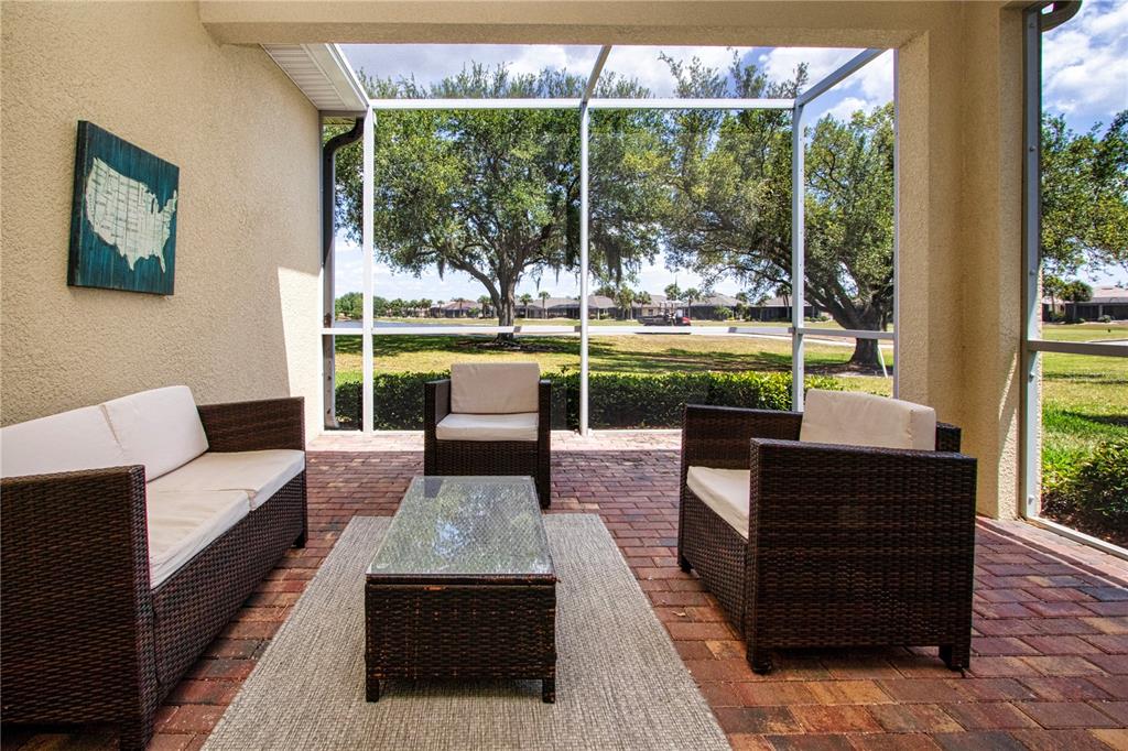 A black front door with a transom window sits in a stucco entryway — 804 CHIPPER DRIVE, SUN CITY CENTER, FL