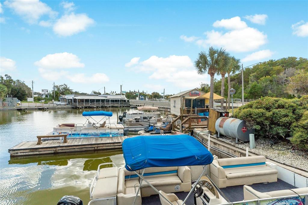 A view of a marina with several pontoon boats docked on the water — 1006 W BURLEIGH BOULEVARD, TAVARES, FL