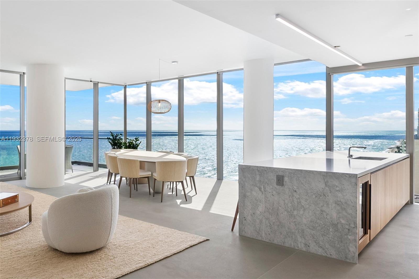 A modern open-plan kitchen and dining area features floor-to-ceiling windows overlooking the ocean — 2000 S Ocean Dr # 18B, Hallandale Beach FL 33009, HALLANDALE BEACH, FL