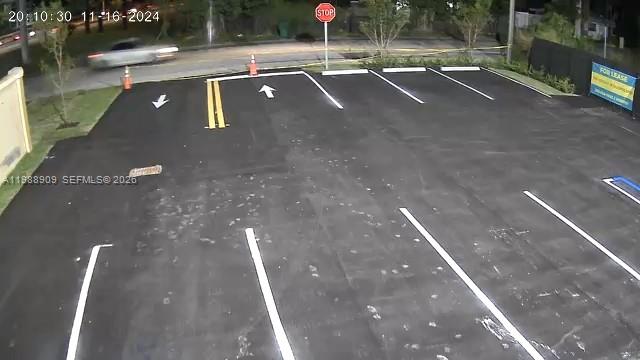 An elevated view shows a newly paved parking lot with white painted parking space lines — 11890 SW 220th St, Miami FL 33170, MIAMI, FL