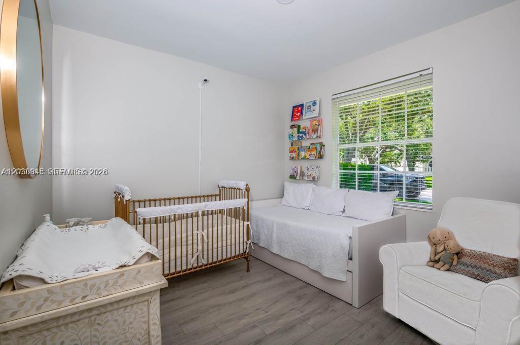 A nursery features a gold crib, a daybed, a changing table, and a white armchair — 8325 NW 161st Ter, Miami Lakes FL 33016, MIAMI LAKES, FL