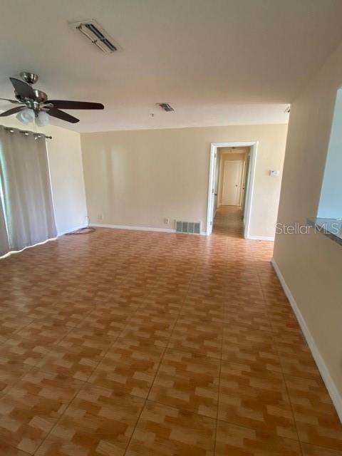 A living room with light-colored walls, wood-look tile flooring, and a ceiling fan — 3131 LITTLE SOUND DRIVE, ORLANDO, FL