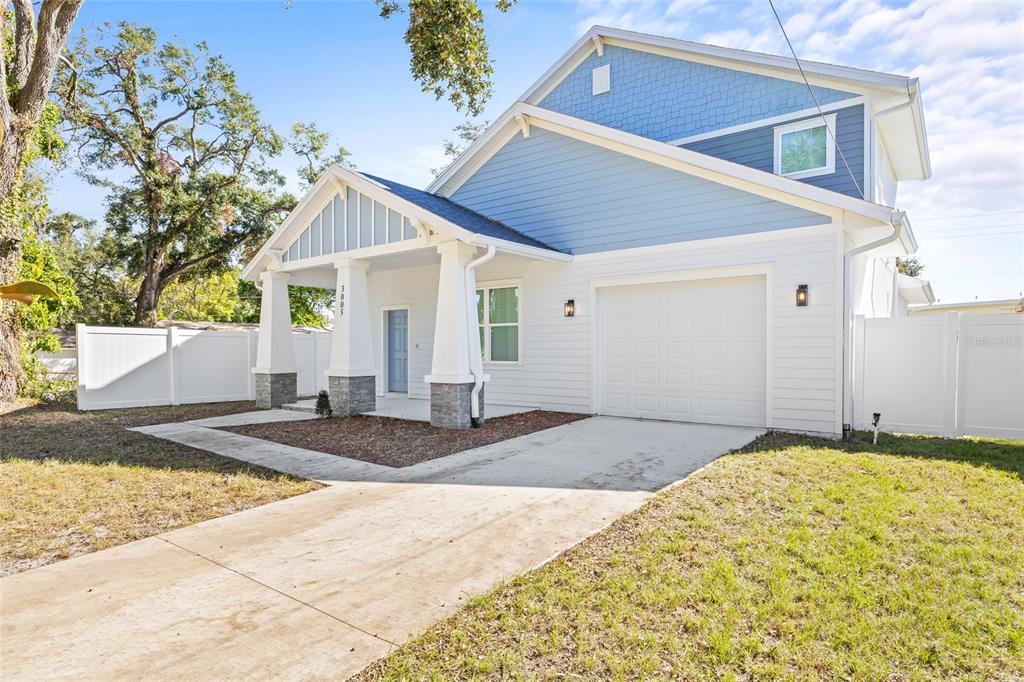 A two-story house with white siding, a blue upper gable, and a front porch — 3005 E 17TH AVENUE, TAMPA, FL