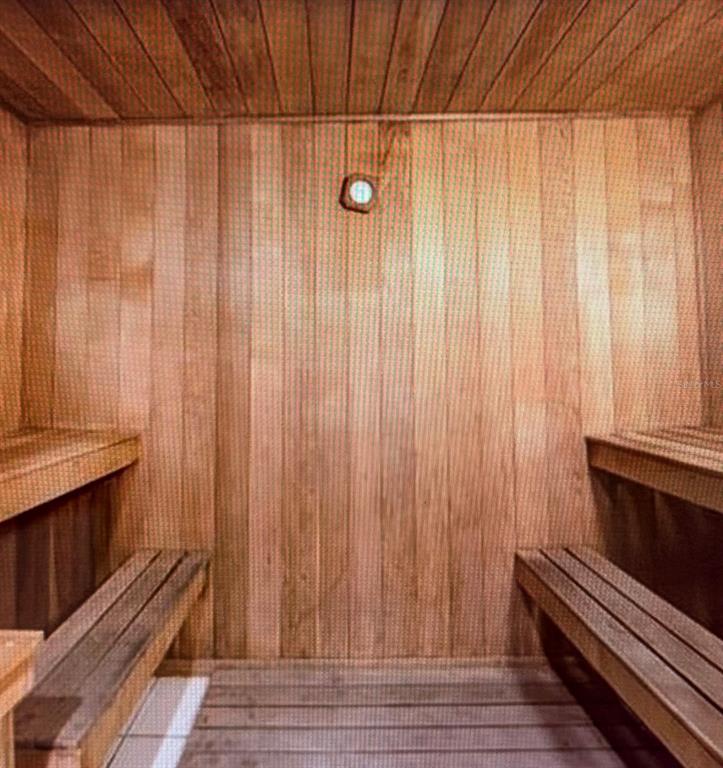 A wood-paneled sauna featuring tiered wooden benches on both sides and a wall-mounted thermometer — 350 NE 24TH STREET UNIT 514, MIAMI, FL