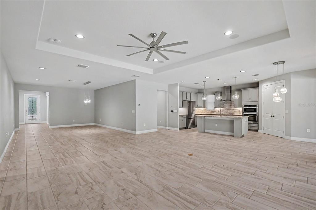 An open-concept living area features a large kitchen with a center island and tile flooring — 11610 DUBLIN GRAFTON DRIVE, RIVERVIEW, FL
