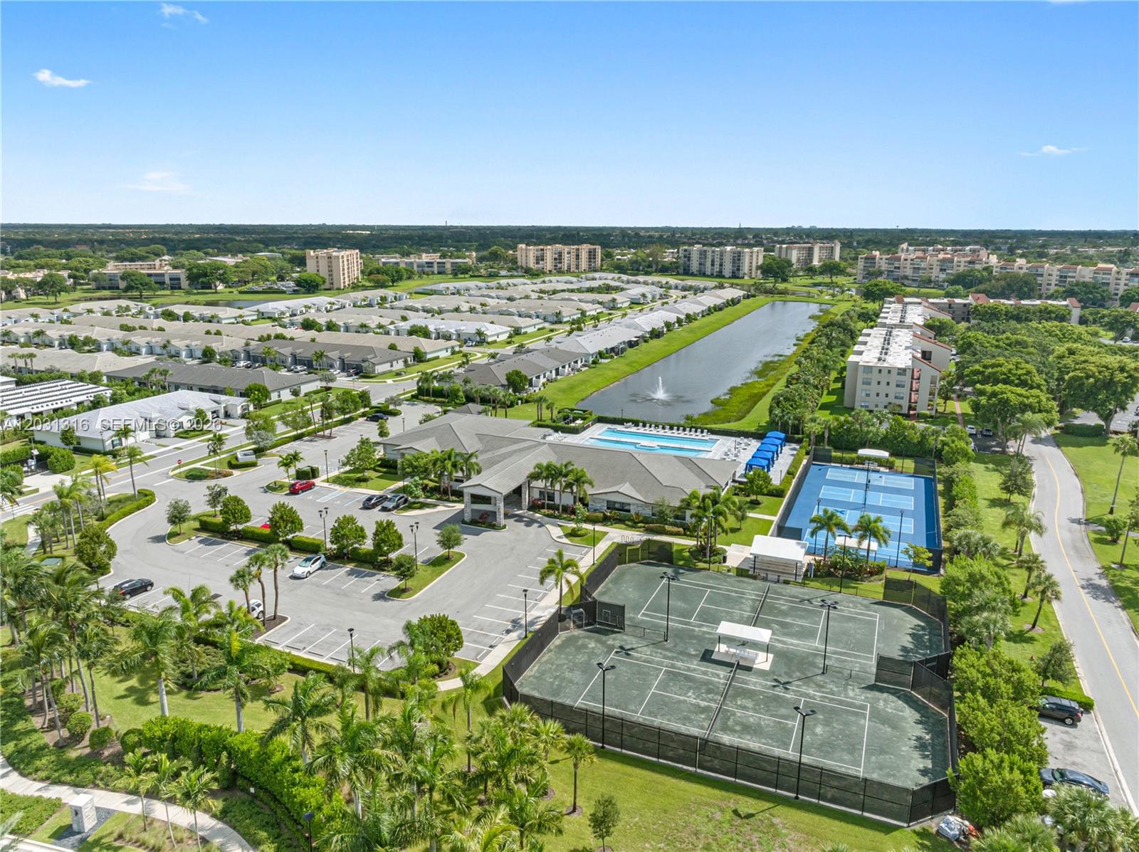 An aerial view shows a community clubhouse with a pool, tennis courts, and parking lot — 7305 Ivory Spring, Delray Beach FL 33446, DELRAY BEACH, FL