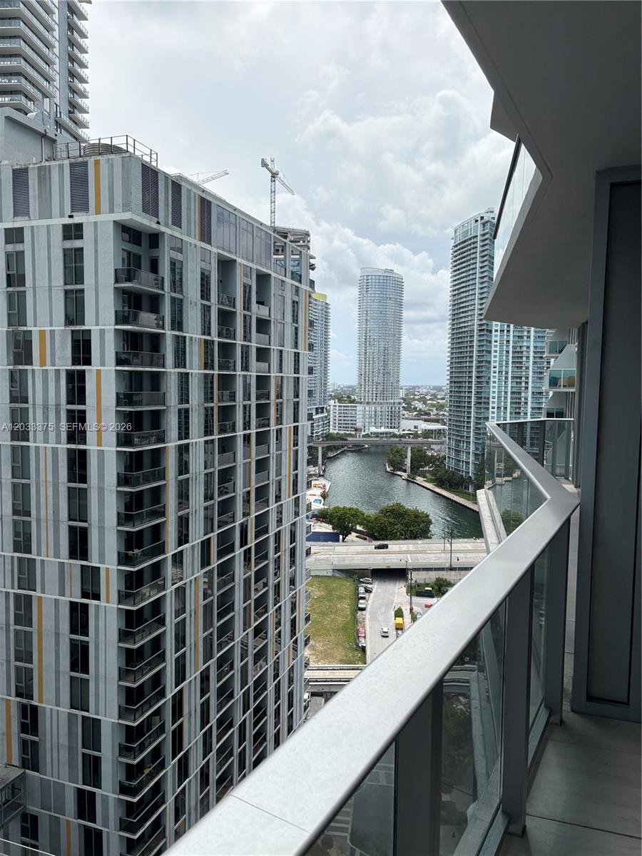 A high-rise balcony view overlooks a river, city buildings, and a bridge — 77 SE 5th Street # 2108, Miami FL 33131, MIAMI, FL