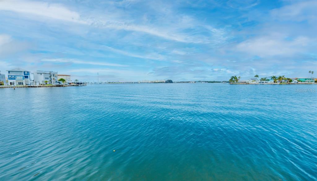 A wide view of a calm bay with waterfront houses visible on both sides — 14217 E PARSLEY DRIVE, ST PETERSBURG, FL