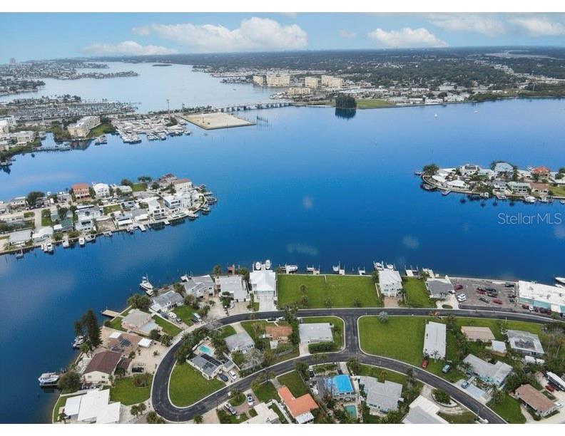 An aerial view shows waterfront homes with private docks along a bay in Florida — 14217 E PARSLEY DRIVE, ST PETERSBURG, FL