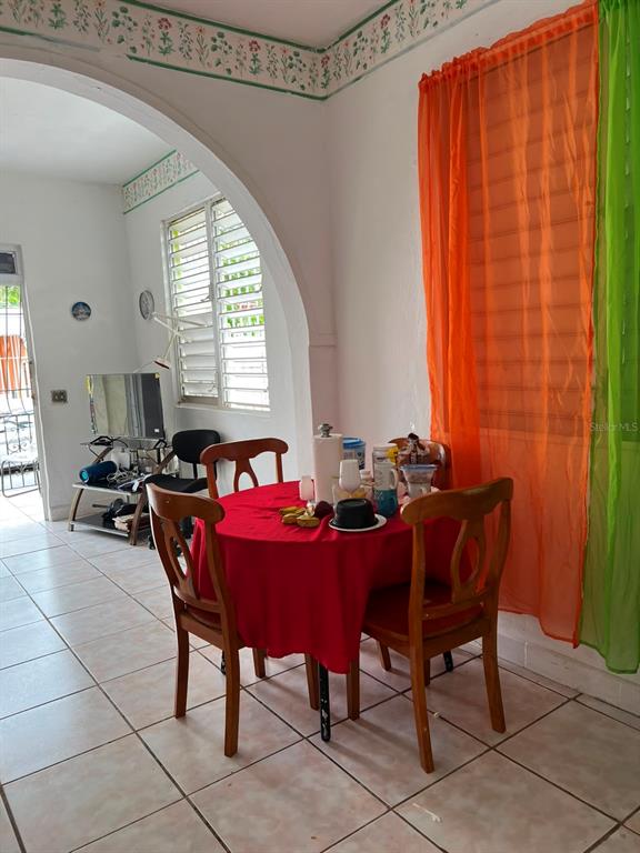 A dining area features a round table with a red tablecloth and four wooden chairs — 258 H BARTOLOME DE LAS CASAS, SANTURCE, SAN JUAN, PR