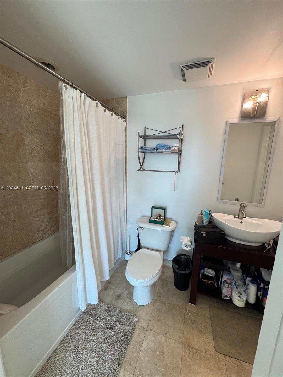 A bathroom features a shower-tub combination, a toilet, and a vessel sink vanity — 350 S Miami Ave # 1812, Miami FL 33130, MIAMI, FL