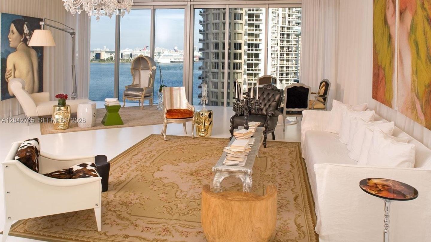 A spacious living room features floor-to-ceiling windows overlooking a harbor and city skyline — 495 Brickell Ave # 4609, Miami FL 33131, MIAMI, FL
