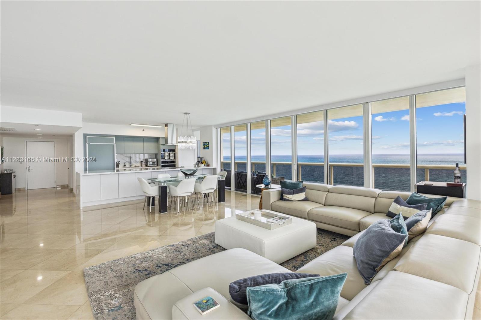 An open-concept living and dining area features floor-to-ceiling windows with expansive ocean views — 1830 S OCEAN DR # 2102, Hallandale Beach FL 33009, HALLANDALE BEACH, FL