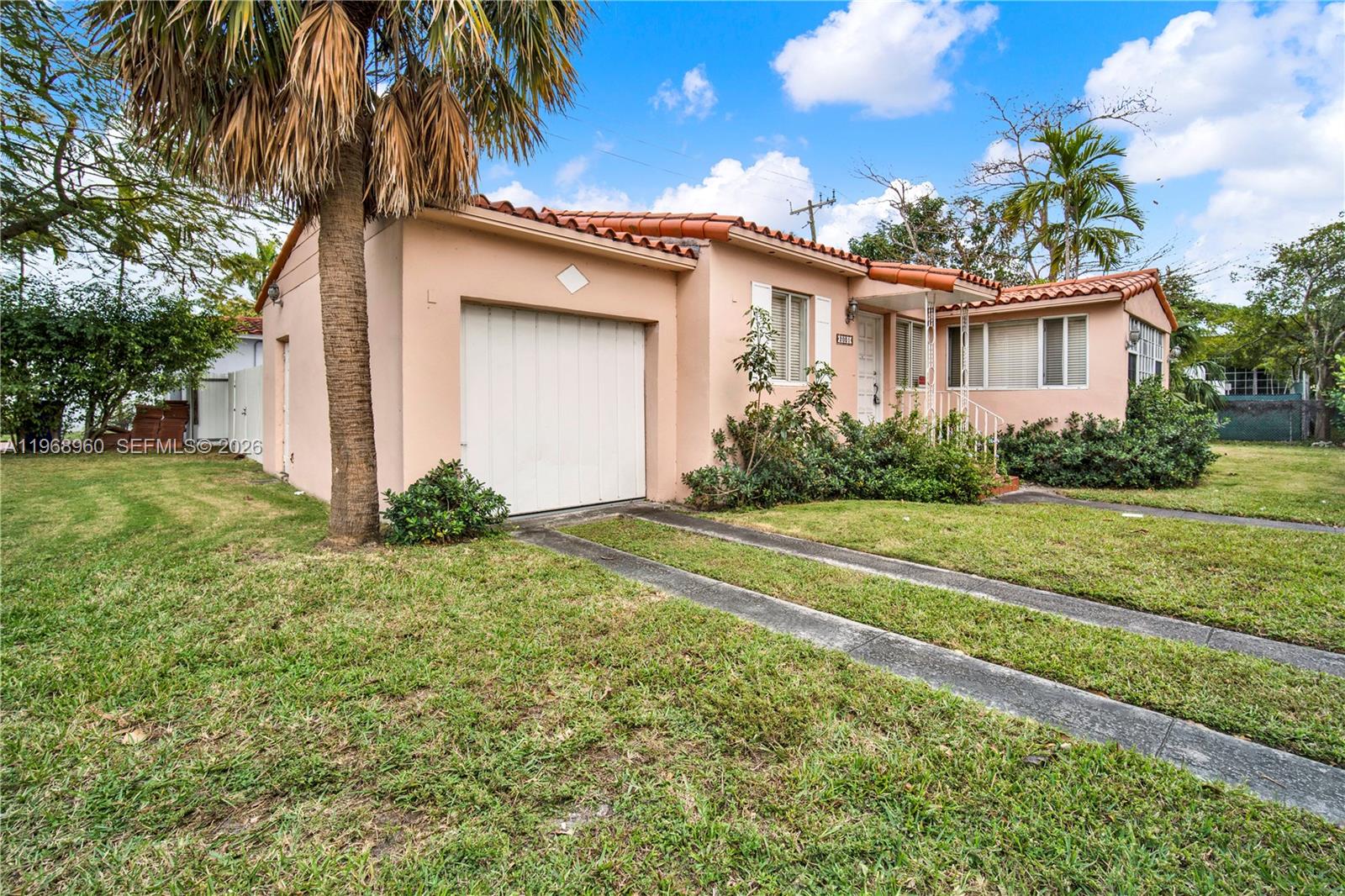 A single-story peach-colored house with a tile roof, a garage, and a front lawn — 2001 SW 37th Ave, Miami FL 33145, MIAMI, FL