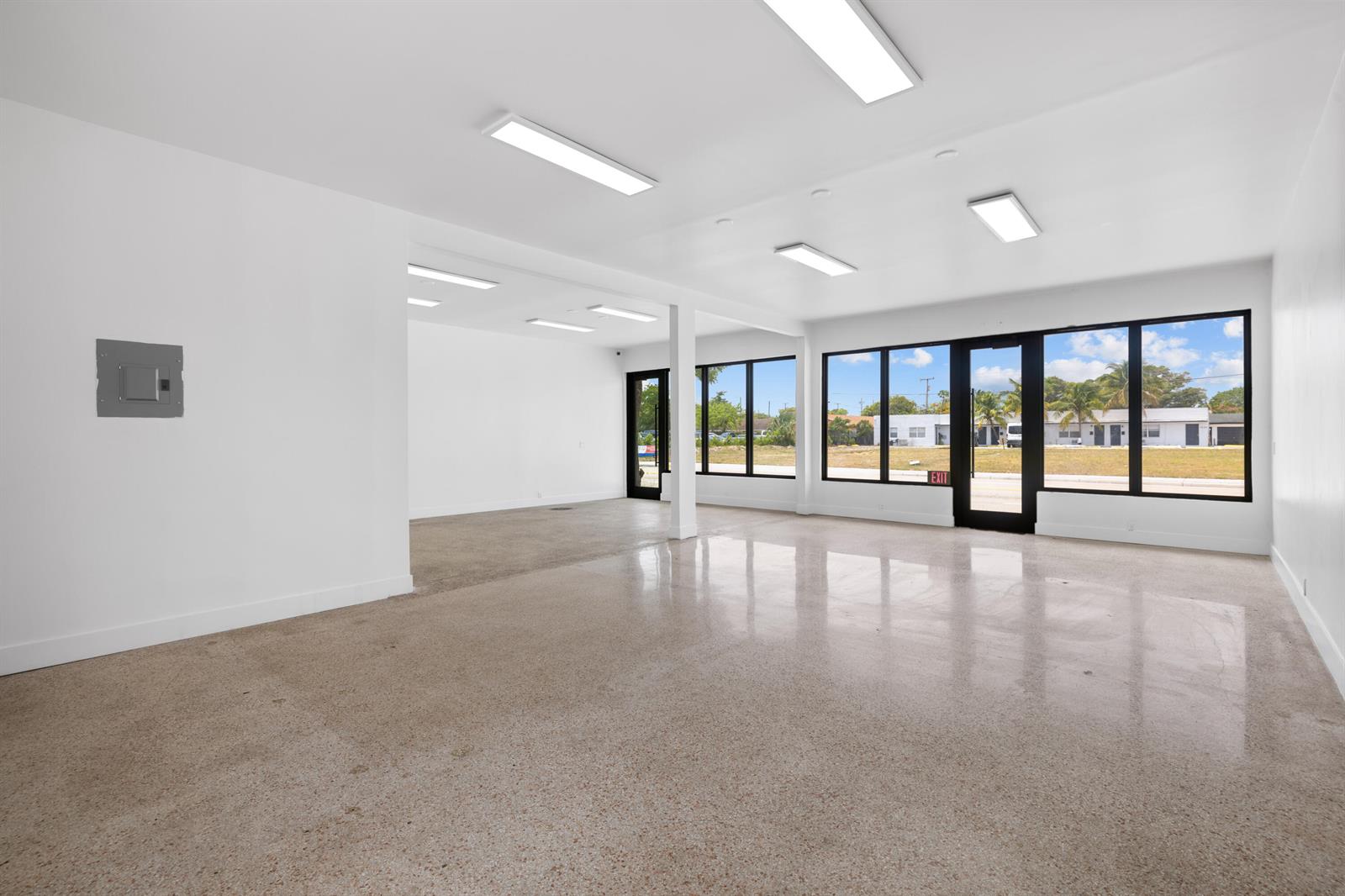 An empty commercial space with white walls, polished concrete floors, and large windows — 1808/1810 N Dixie Highway, FL 33460, FL