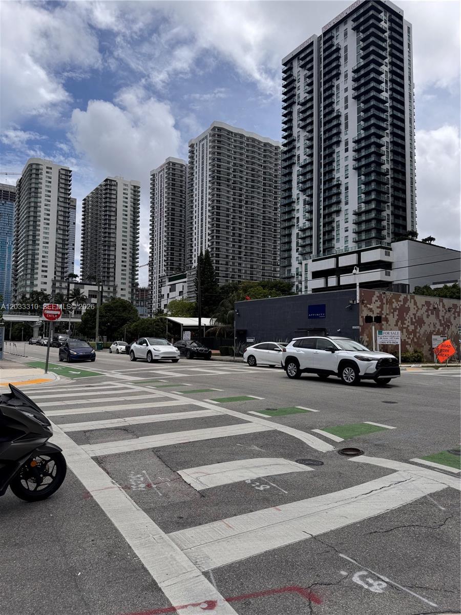 A street-level view shows a crosswalk, several cars, and multiple high-rise apartment buildings — 1600 NE 1st Ave # 2015, Miami FL 33132, MIAMI, FL