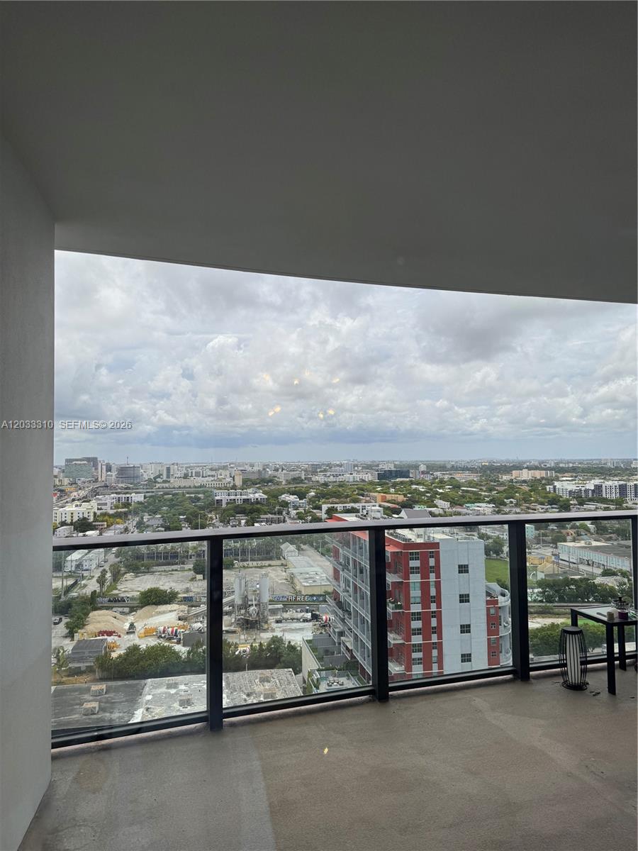 A high-rise balcony overlooks a city skyline with construction sites and residential buildings — 1600 NE 1st Ave # 2015, Miami FL 33132, MIAMI, FL