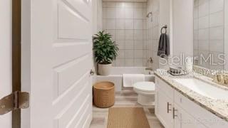 A bathroom features a white vanity with a granite countertop, a tub-shower combo, and tile flooring — 1827 N ROBERTS TRAIL, BELL, FL