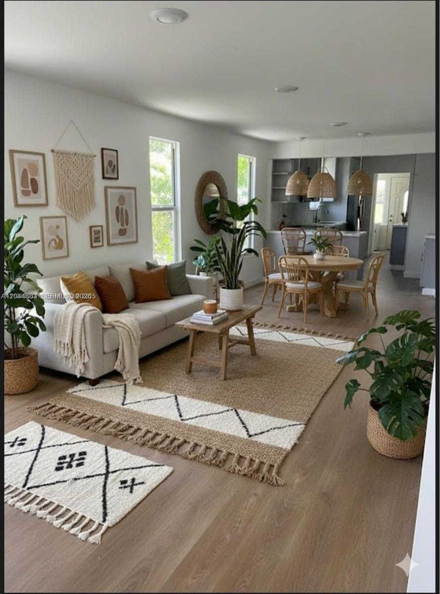 A living room and dining area feature light wood floors, neutral furniture, and woven decor — 81 NW 44th St, Miami FL 33127, MIAMI, FL
