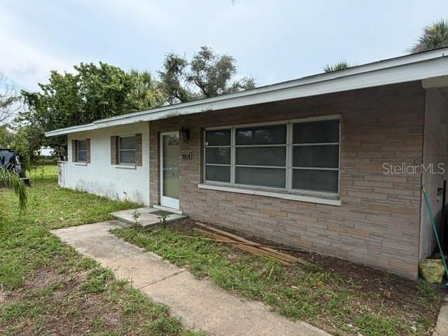 A single-story house features a brick facade, a concrete walkway, and a front entrance — 1604 BAYSHORE ROAD, NOKOMIS, FL