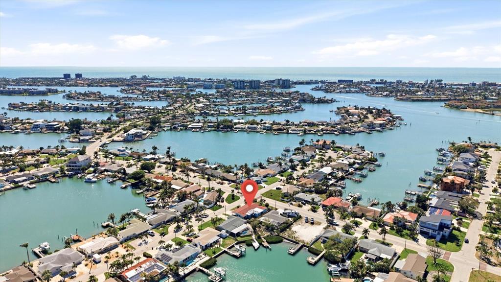 An aerial view shows a waterfront residential neighborhood with a red map pin marker — 7891 4TH AVENUE S, ST PETERSBURG, FL