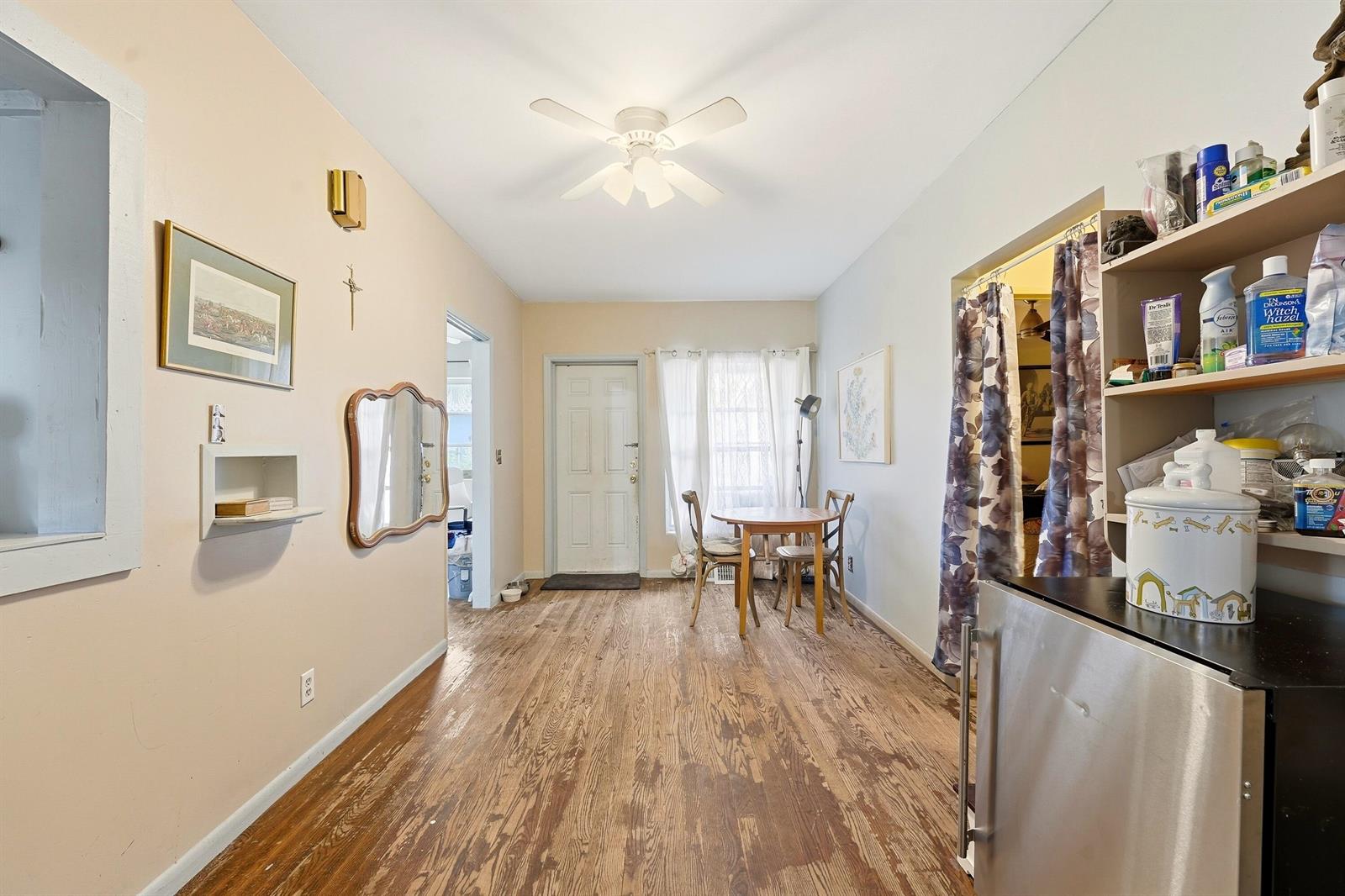 A dining area with wood flooring, a ceiling fan, a small table, and open shelving — 515 Biscayne Drive, West Palm Beach FL 33401, WEST PALM BEACH, FL