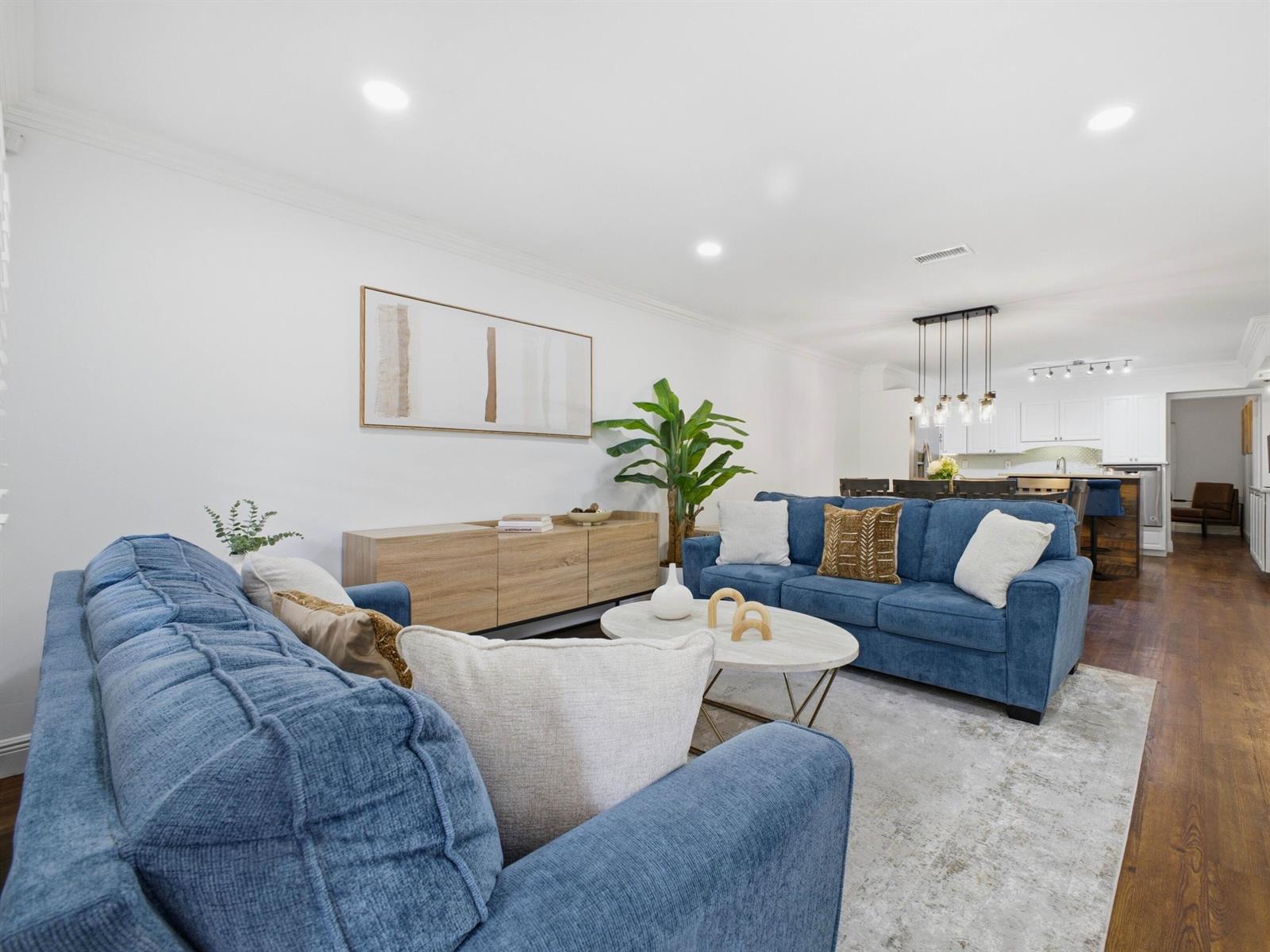 A living room with two blue sofas, a wooden console, and a white coffee table — 5120 NE 22nd Avenue, Lighthouse Point FL 33064, LIGHTHOUSE POINT, FL