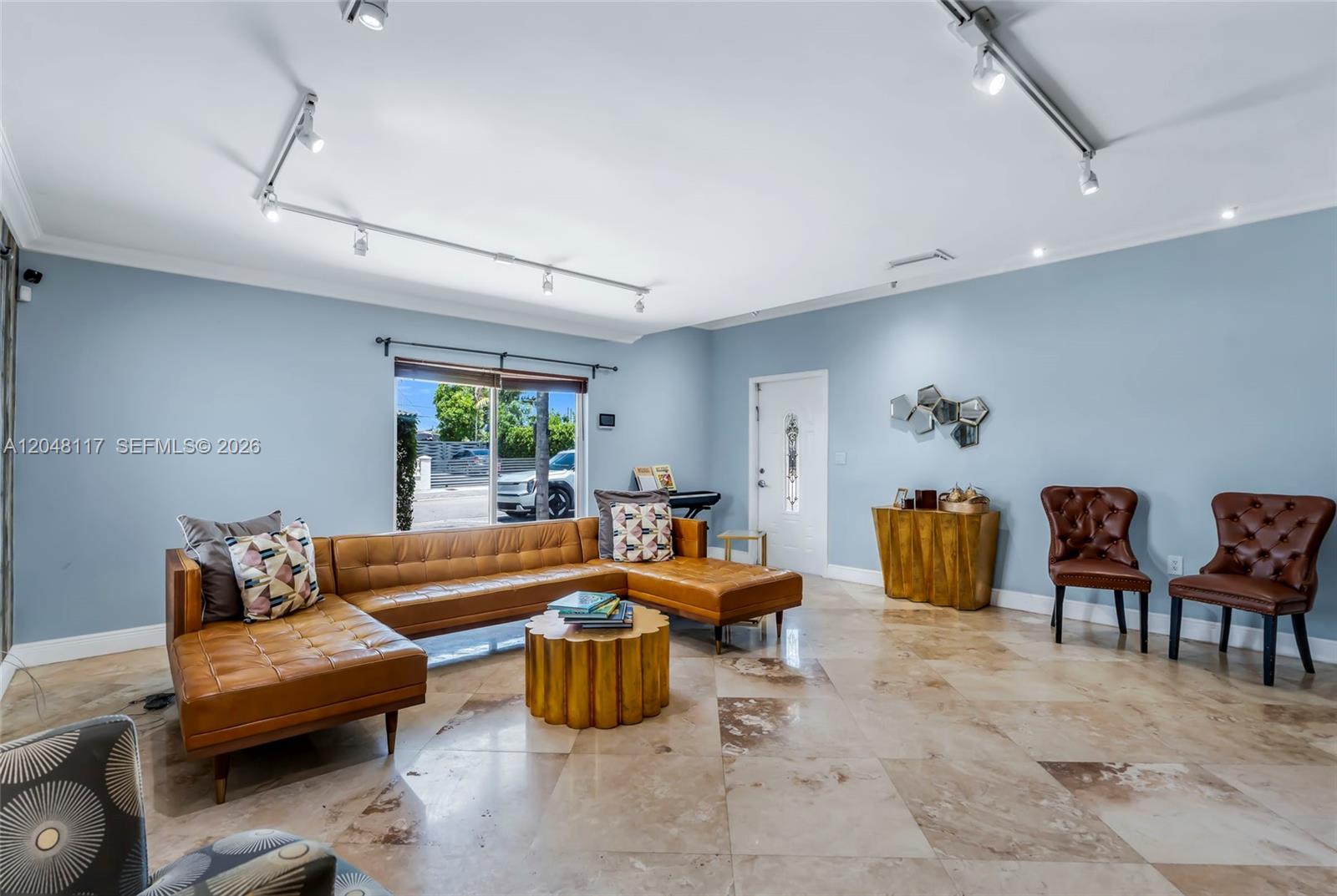 A living room features a tan leather sectional, two brown chairs, and light-colored tile floors — 114 SW SW 57th Ct, Miami FL 33144, MIAMI, FL