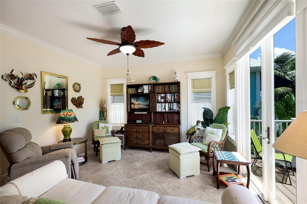 A staircase with beige tile steps and a wooden handrail leads to a landing — 309 68TH STREET, HOLMES BEACH, FL