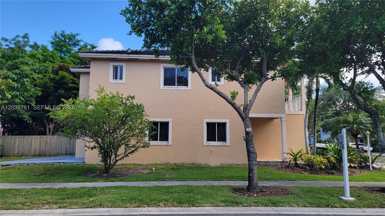 A two-story tan stucco building with a front lawn and mature trees — 391 NE 33rd Ter, Homestead FL 33033, HOMESTEAD, FL