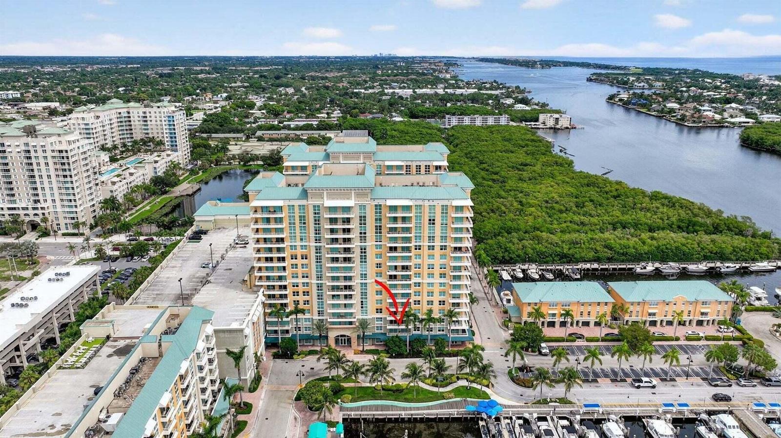 An aerial view shows a multi-story residential building with a red arrow pointing to a balcony — 625 Casa Loma Boulevard # 304, Boynton Beach FL 33435, BOYNTON BEACH, FL