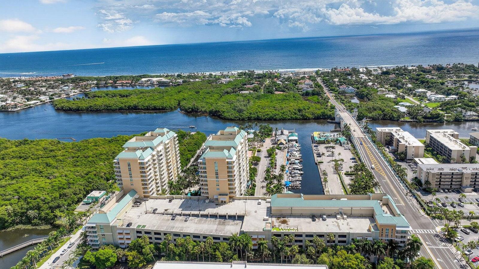 An aerial view shows high-rise residential buildings, a parking garage, a marina, and a bridge — 625 Casa Loma Boulevard # 304, Boynton Beach FL 33435, BOYNTON BEACH, FL