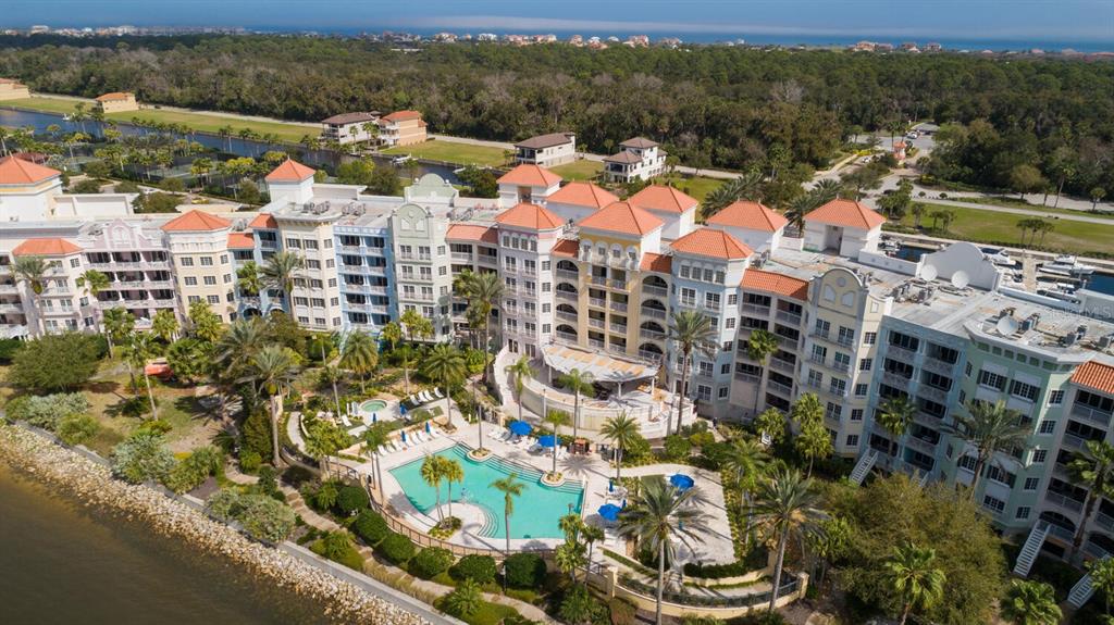 An aerial view of a multi-story resort complex with a swimming pool and waterfront access — 102 YACHT HARBOR DRIVE UNIT 264, PALM COAST, FL