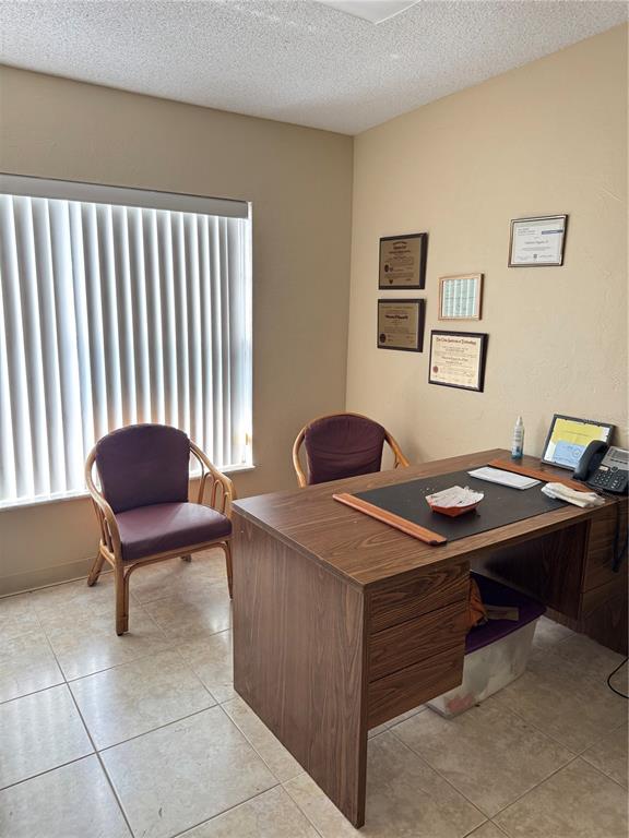 An office features a wooden desk, two purple chairs, and framed certificates on the wall — 1025 W OAK RIDGE ROAD, ORLANDO, FL