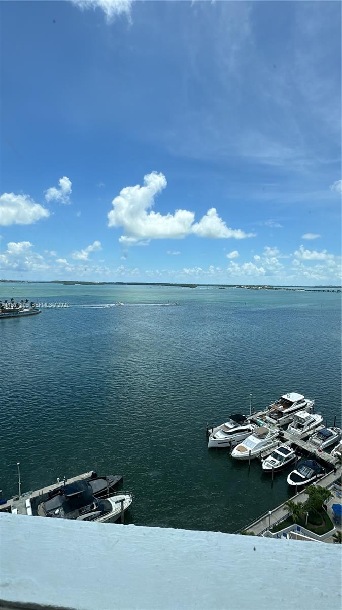 An elevated view of a marina with several yachts docked in calm blue water — 905 Brickell Bay Dr # B, Miami FL 33131, MIAMI, FL