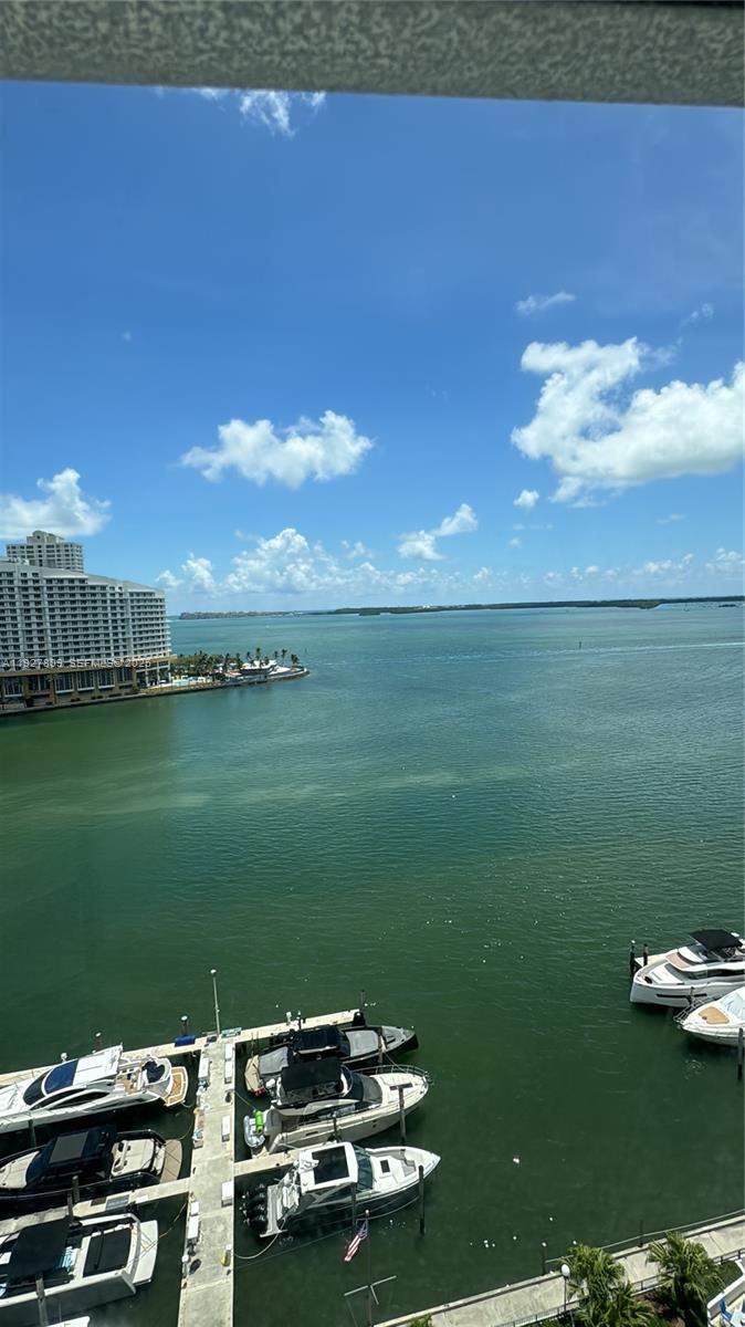 A high-angle view of a bay with docked boats and a large building nearby — 905 Brickell Bay Dr # B, Miami FL 33131, MIAMI, FL
