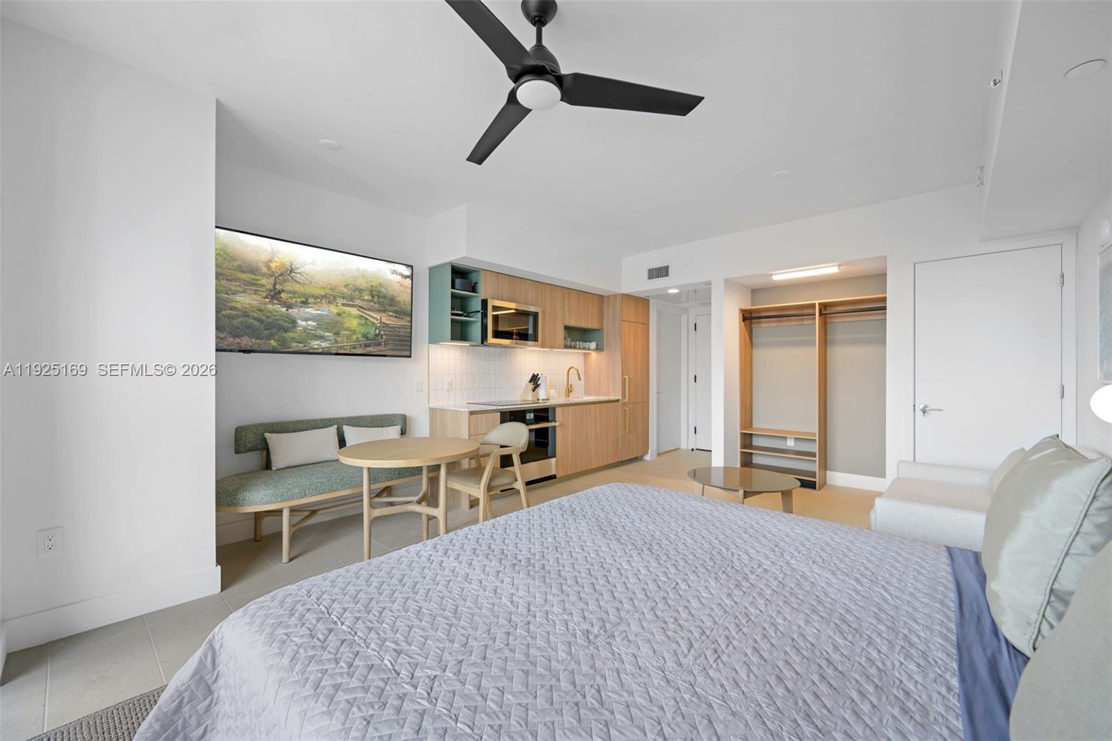 A studio apartment features a kitchenette, a dining area, and a bed — 159 NE 6th St # 3810, Miami FL 33132, MIAMI, FL