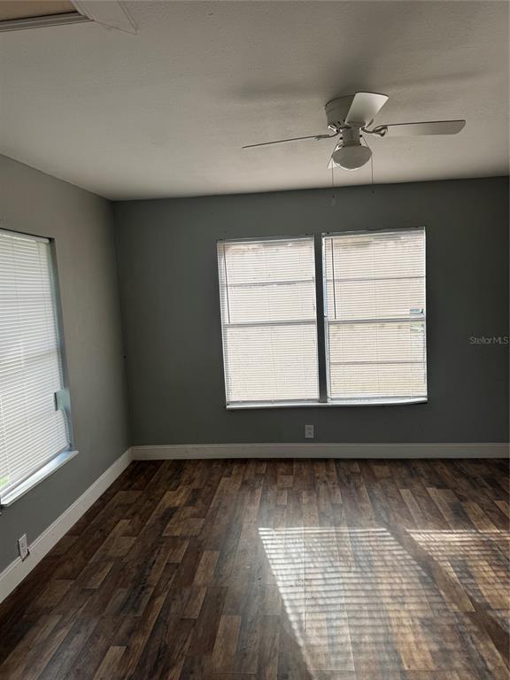 An empty bedroom with gray walls, wood-look flooring, and a ceiling fan — 7001 COLUMBIA DRIVE, MULBERRY, FL
