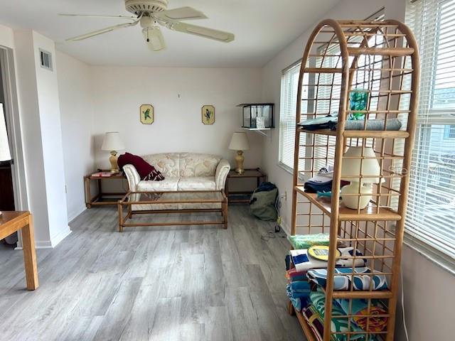 A living room features a light-colored sofa, a wooden coffee table, and a tall wicker shelf — 347 MARINER DRIVE, NORTH PORT, FL