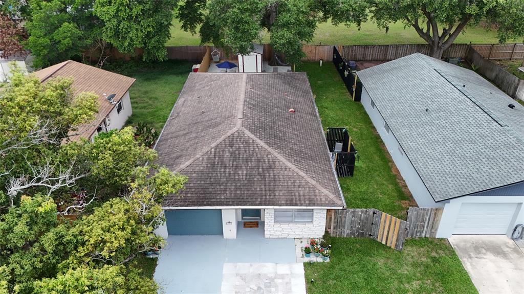 An aerial view shows a single-story house with a dark roof and a front driveway — 536 HIBISCUS WAY UNIT 7B, ORLANDO, FL
