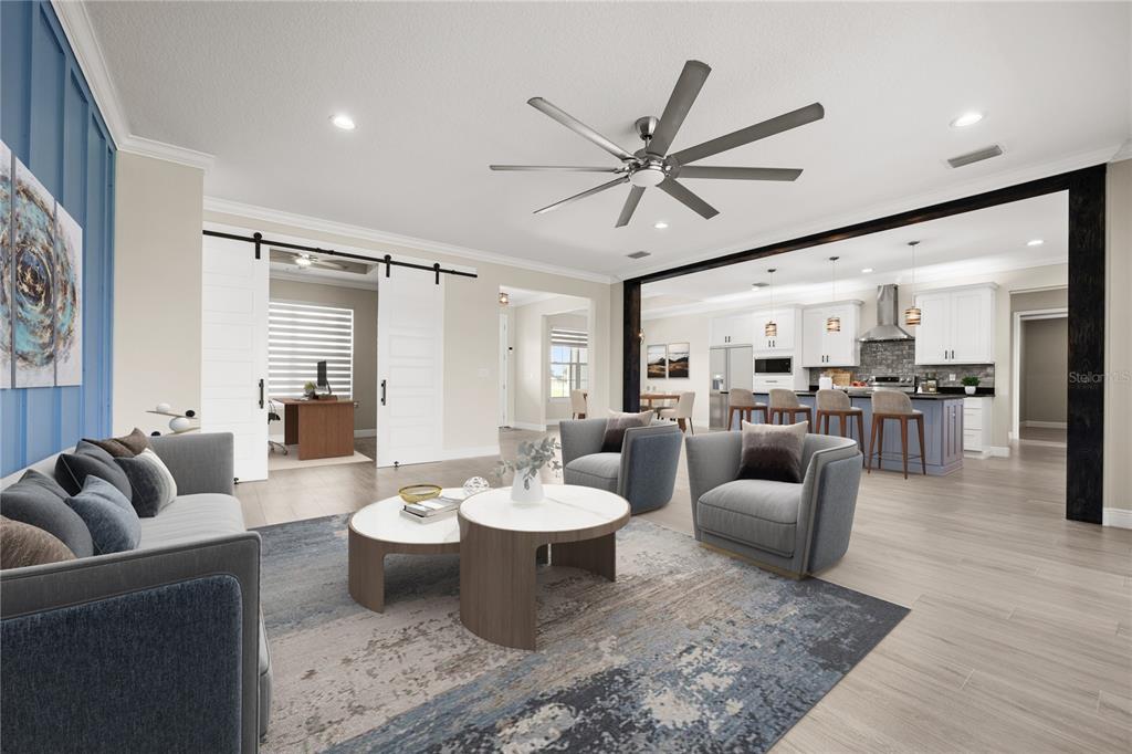 This rendering shows an open-concept living room and kitchen with gray furniture and barn doors — 8715 NW 18TH CIRCLE, OCALA, FL