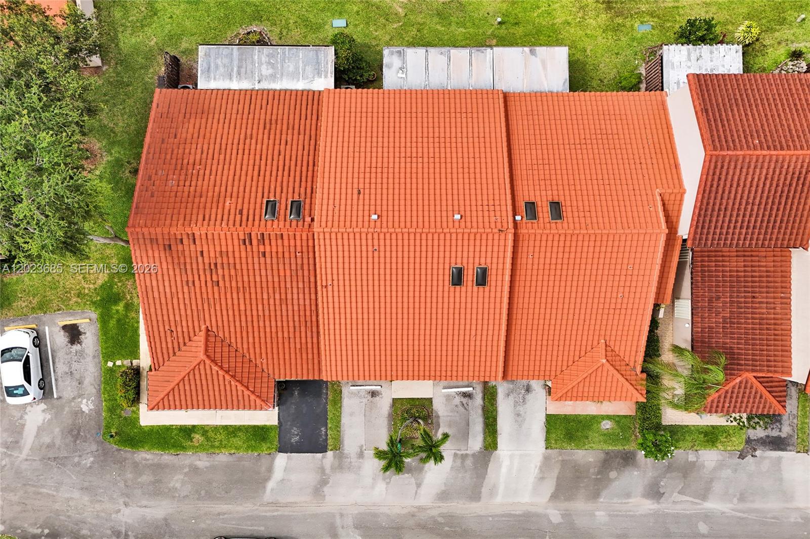An aerial view shows the red tile roofs of a multi-unit residential building — 3273 W Inverrary Blvd W, Lauderhill FL 33319, LAUDERHILL, FL