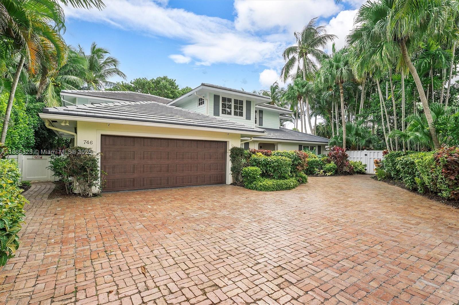 A two-story house with a brick driveway, a brown garage door, and lush tropical landscaping — 746 Marble Ct, Boca Raton FL 33432, BOCA RATON, FL